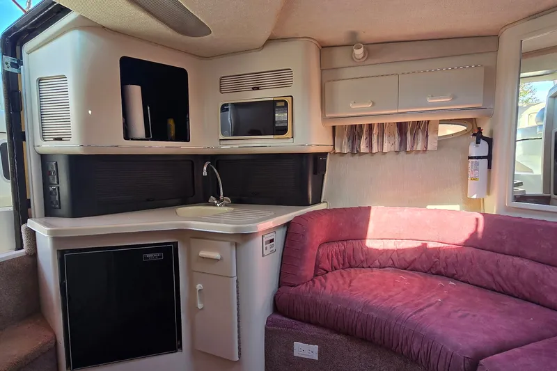 Slide: The Image of Interior of a 1992 Sea Ray 380 Sun Sport with kitchenette and seating area. - 18