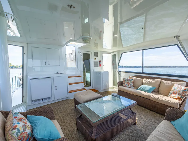 Slide: The Image of Bright salon of a 1995 Hatteras 52 Cockpit Motor Yacht with comfortable sofas and large window. - 32