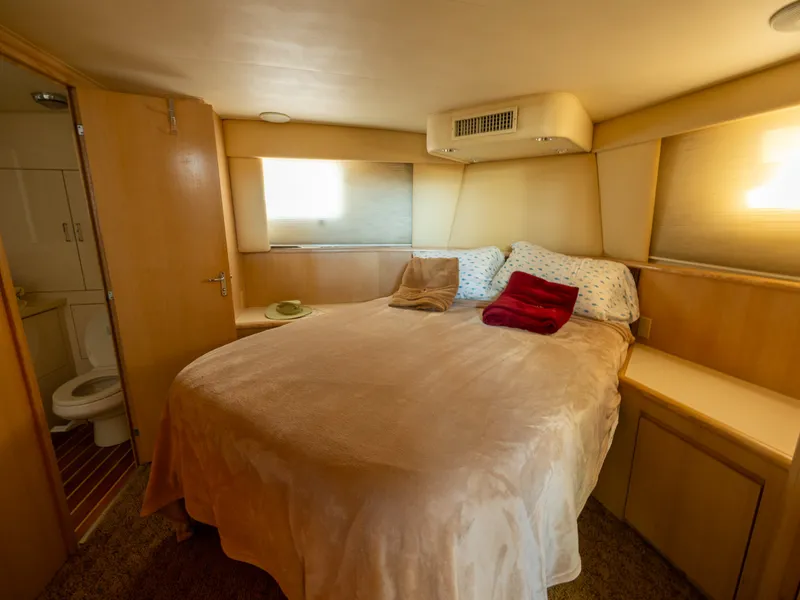 Slide: The Image of The image shows a cozy cabin with a large bed, wooden furnishings, and an adjoining bathroom. - 44