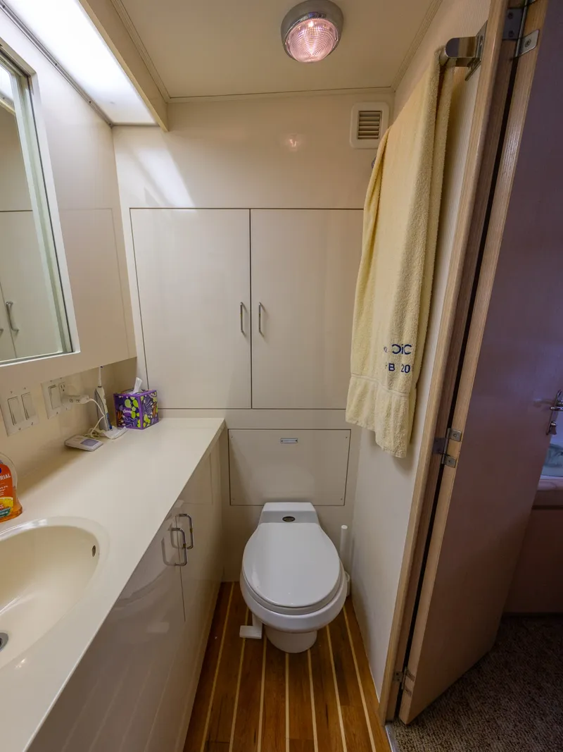 Slide: The Image of The image shows a yacht bathroom with a sink, toilet, and towel. - 48