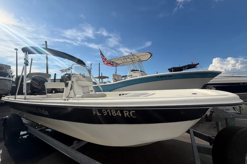 The Image of 2017 Mako Pro Skiff 19 CC boat on trailer under clear blue sky. - 0