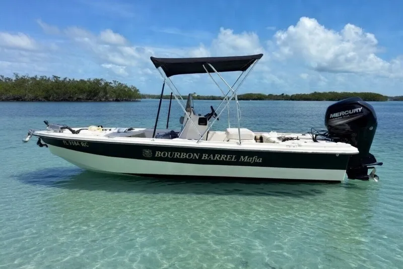 The Image of 2017 Mako Pro Skiff 19 CC boat on clear water with Mercury engine. - 2