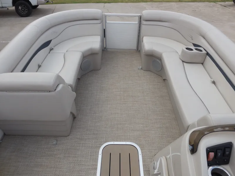 Slide: The Image of Interior view of a Bennington 22 SSx APG pontoon boat with beige seating and carpeted floor. - 22
