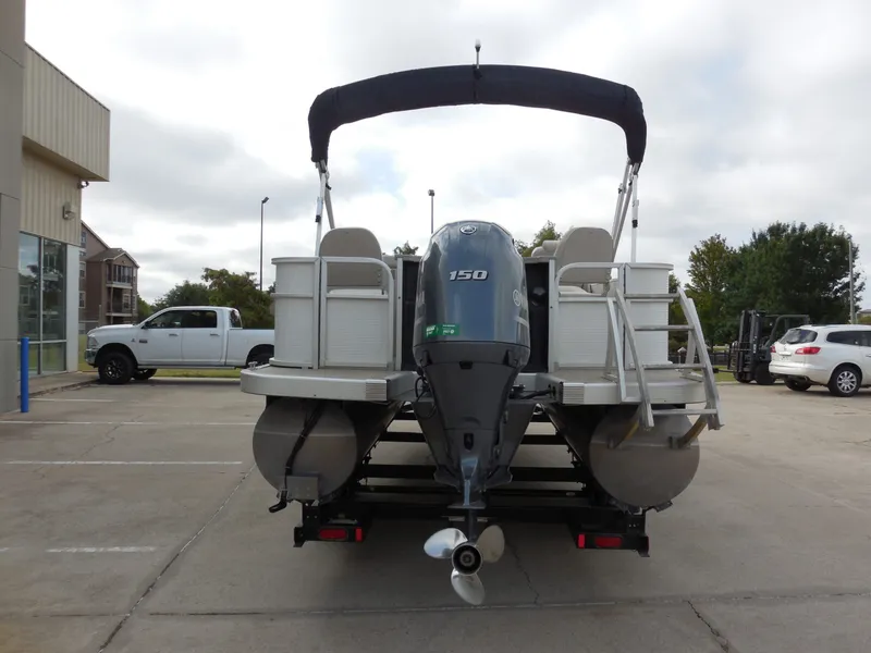 Slide: The Image of A 2019 Bennington 22 SSx APG pontoon boat with a 150 HP outboard motor, parked on a trailer. - 4