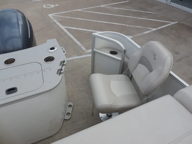 Slide: The Image of A 2019 Bennington 22 SSx APG with a beige seat and helm console. - 19