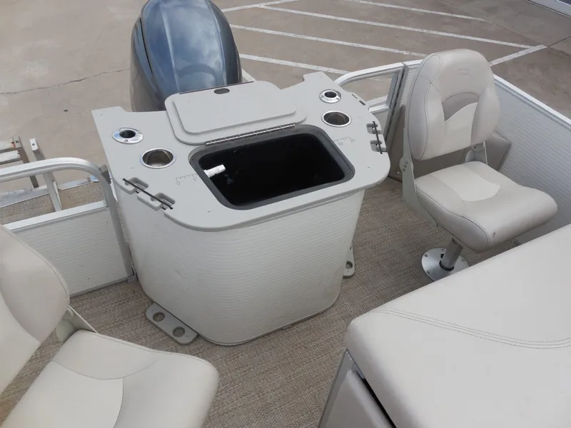 Slide: The Image of The image shows the interior of a 2019 Bennington 22 SSx APG with beige seats and a motor. - 18