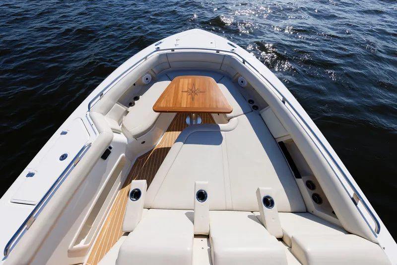 Slide: The Image of Luxurious seating area on 2020 Boston Whaler 380 Realm boat, featuring elegant wooden table. - 61