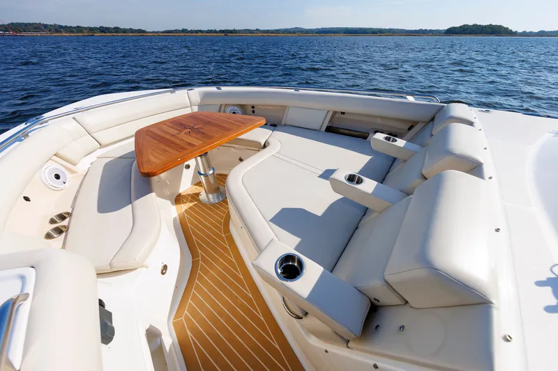 Slide: The Image of Luxurious seating area on 2020 Boston Whaler 380 Realm boat with wooden table. - 59