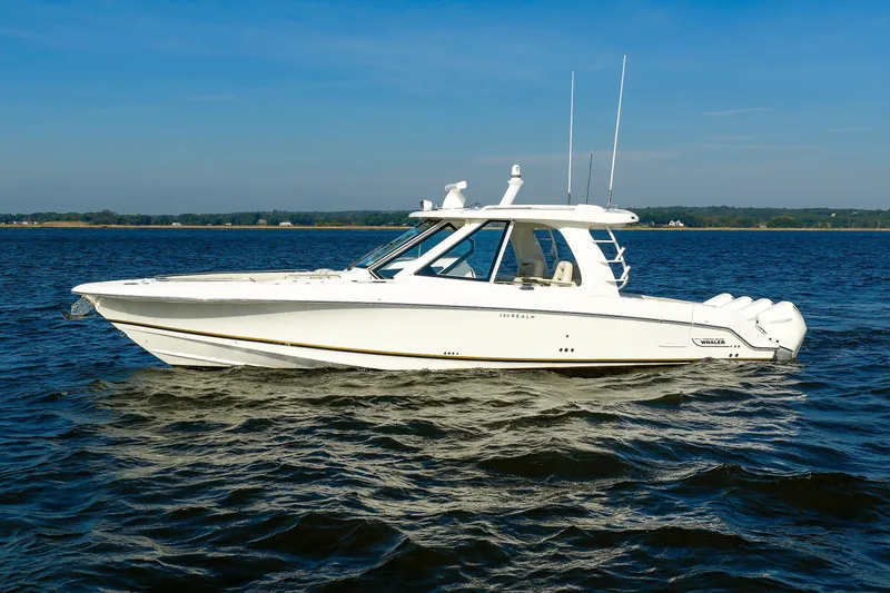 Slide: The Image of 2020 Boston Whaler 380 Realm boat cruising on open water under clear skies. - 6