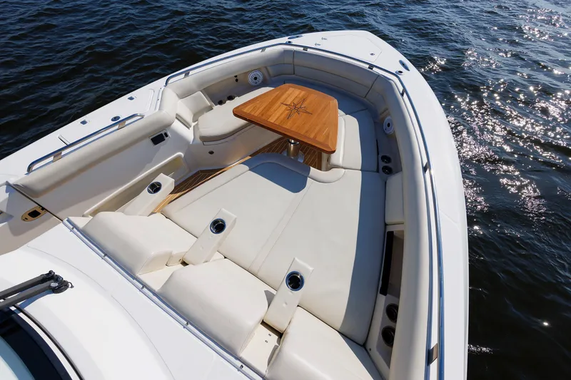 Slide: The Image of Luxurious seating area on 2020 Boston Whaler 380 Realm boat, featuring elegant wooden table. - 62