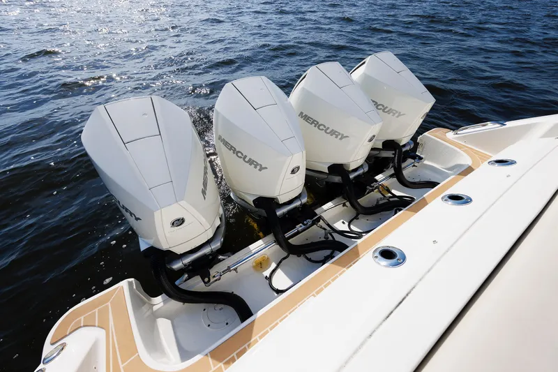 Slide: The Image of 2020 Boston Whaler 380 Realm with four Mercury outboard engines on water. - 31