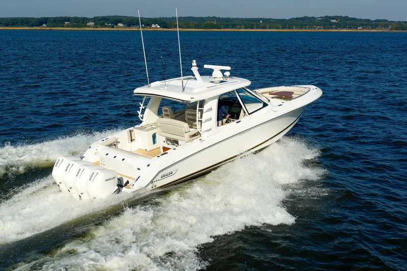 Slide: The Image of 2020 Boston Whaler 380 Realm cruising on open water, showcasing sleek design and powerful engines. - 17