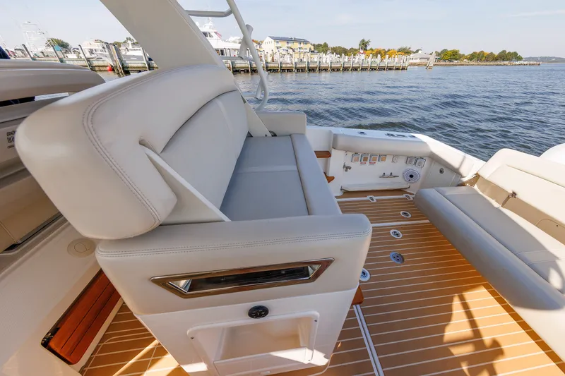 Slide: The Image of 2020 Boston Whaler 380 Realm boat interior with luxurious seating and waterfront view. - 46