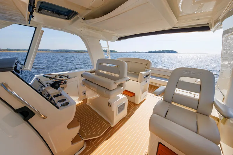 Slide: The Image of Interior view of 2020 Boston Whaler 380 Realm boat with luxurious seating and ocean backdrop. - 49