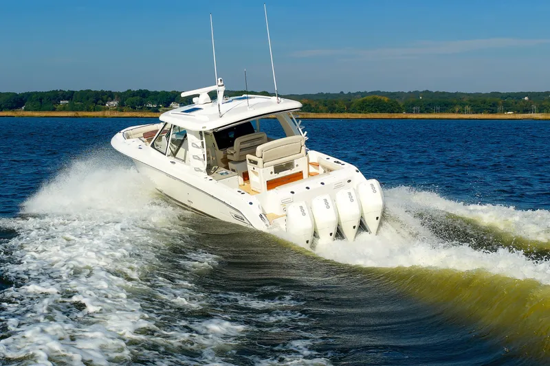 Slide: The Image of 2020 Boston Whaler 380 Realm cruising on open water, showcasing powerful engines and sleek design. - 27