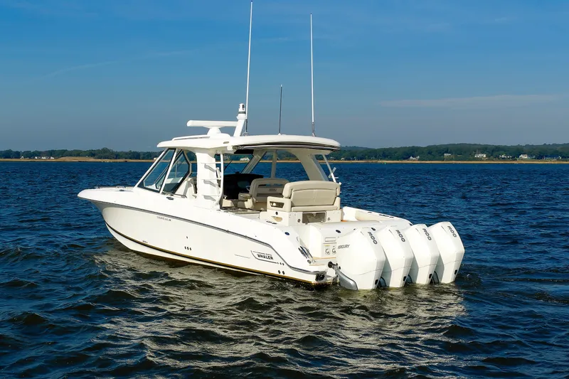 Slide: The Image of 2020 Boston Whaler 380 Realm boat on open water, featuring four powerful outboard engines. - 8