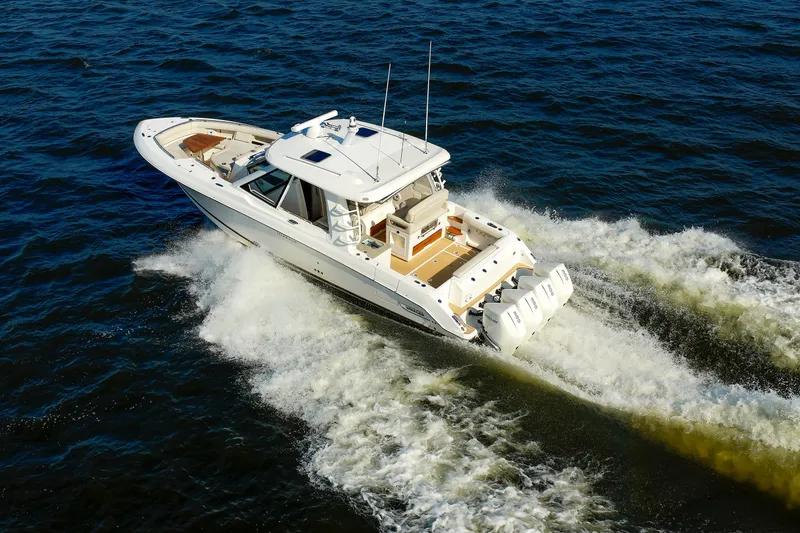 Slide: The Image of 2020 Boston Whaler 380 Realm cruising on open water, showcasing powerful engines and sleek design. - 19