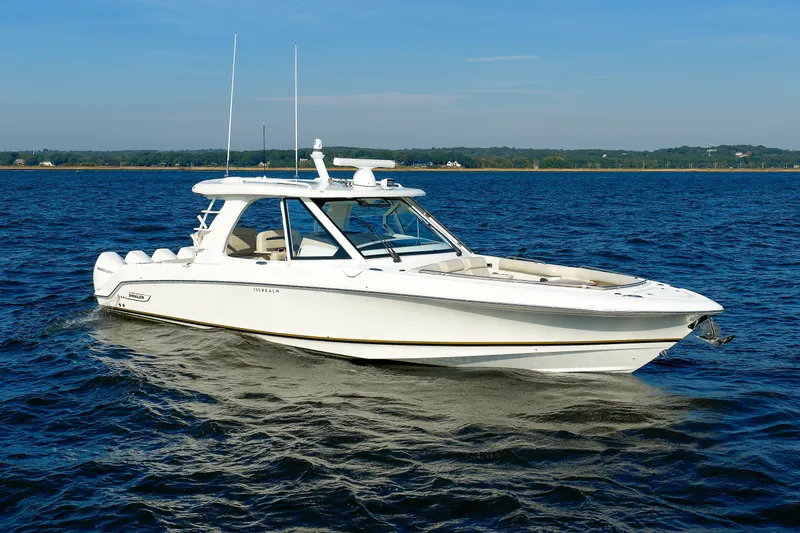 The Image of 2020 Boston Whaler 380 Realm cruising on open water under clear skies. - 1