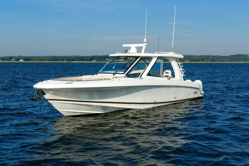 Slide: The Image of 2020 Boston Whaler 380 Realm boat on calm water under clear blue sky. - 4