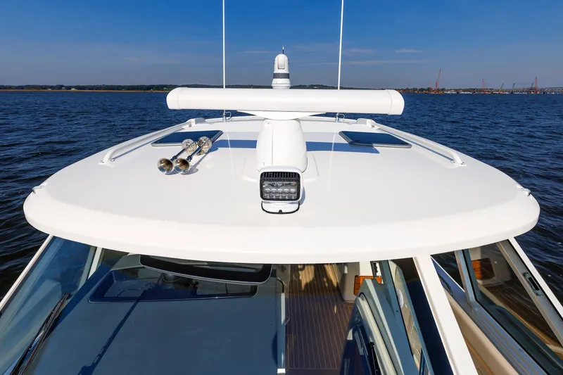 Slide: The Image of 2020 Boston Whaler 380 Realm boat on water, showcasing sleek design and advanced features. - 65