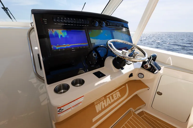 Slide: The Image of 2020 Boston Whaler 380 Realm helm with advanced navigation displays and steering wheel. - 51