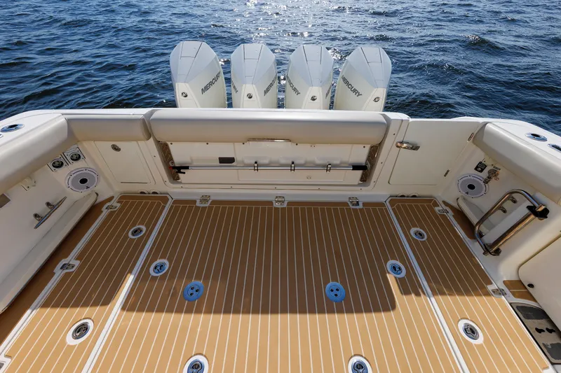 Slide: The Image of 2020 Boston Whaler 380 Realm boat deck with Mercury engines, featuring spacious layout and teak flooring. - 32