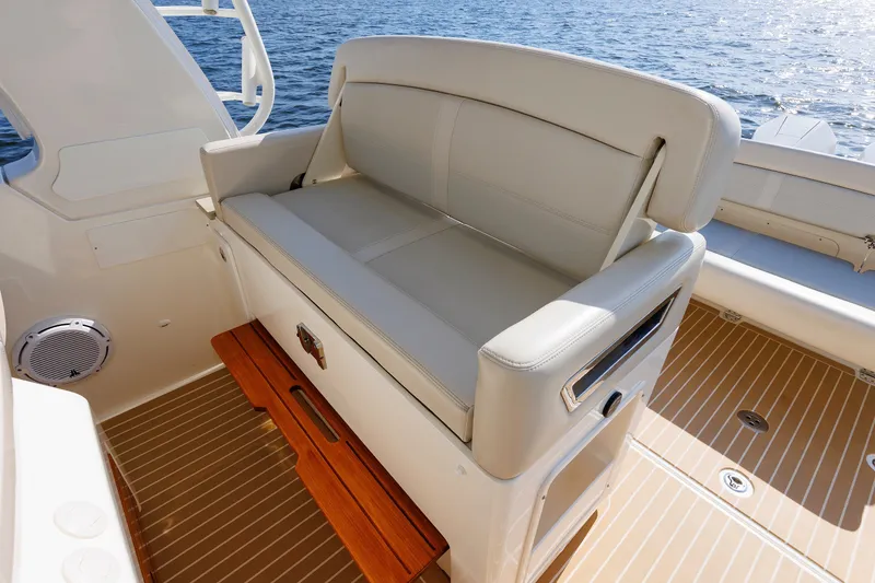 Slide: The Image of Luxurious seating on 2020 Boston Whaler 380 Realm boat, overlooking serene water. - 47