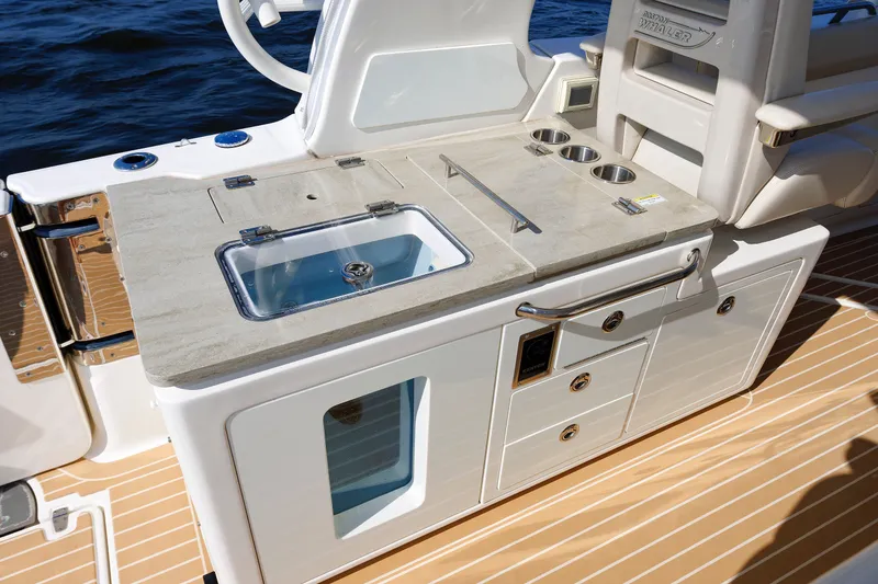 Slide: The Image of Boston Whaler 380 Realm 2020 boat kitchen area with sink and storage. - 41