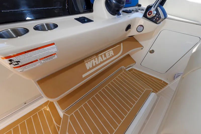 Slide: The Image of 2020 Boston Whaler 380 Realm interior with branded step and control panel. - 52