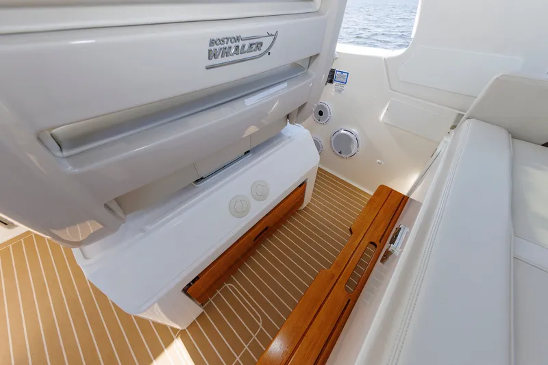 Slide: The Image of Interior of 2020 Boston Whaler 380 Realm, featuring sleek seating and wooden accents. - 48