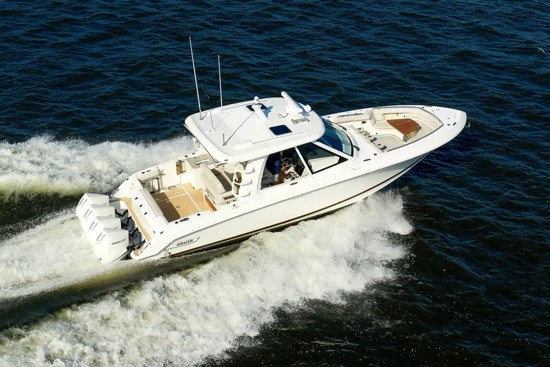 Slide: The Image of 2020 Boston Whaler 380 Realm cruising on open water, showcasing sleek design and powerful engines. - 18