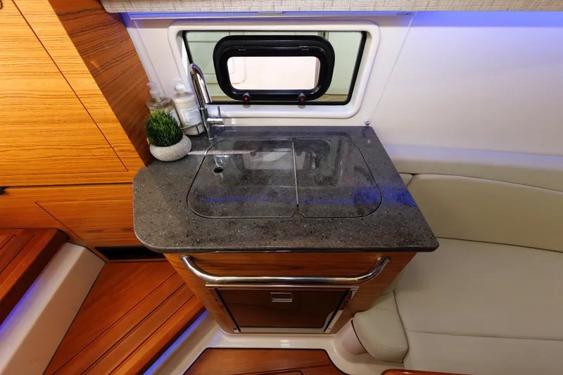 Slide: The Image of 2020 Boston Whaler 380 Realm interior with sleek kitchenette and modern design. - 68