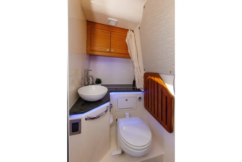 Slide: The Image of Luxurious bathroom interior of 2020 Boston Whaler 380 Realm boat, featuring modern sink and toilet. - 74