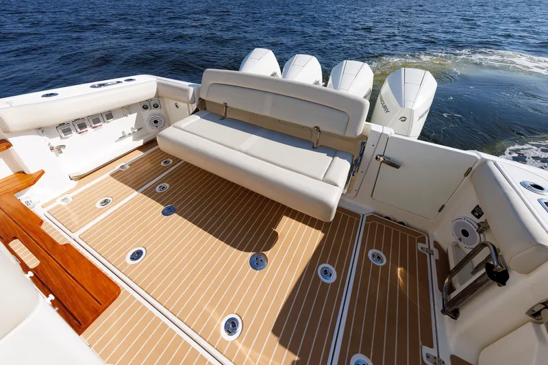 Slide: The Image of 2020 Boston Whaler 380 Realm boat interior with seating and outboard motors on water. - 35