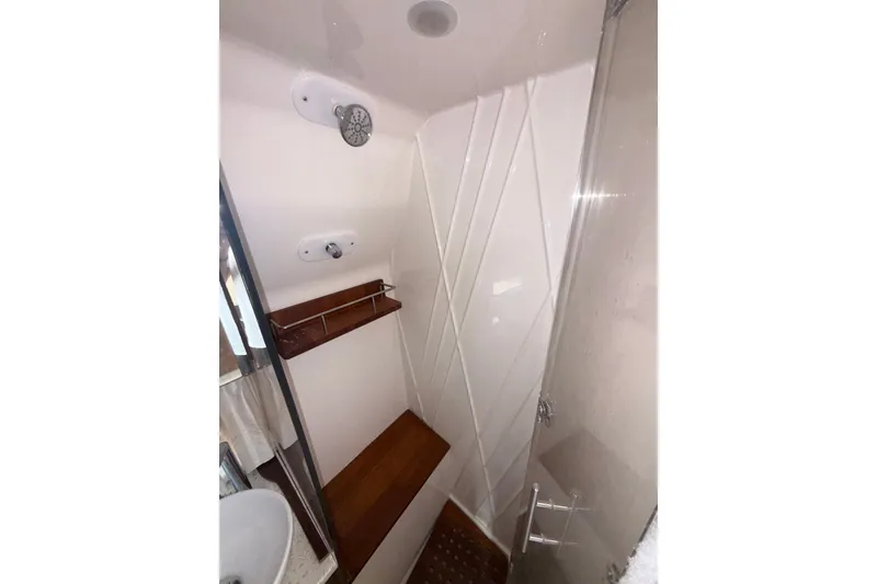 Slide: The Image of Shower area in 2019 Regal 33 SAV boat with wooden accents and modern fixtures. - 22