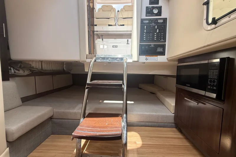 Slide: The Image of Interior of 2019 Regal 33 SAV boat with seating, ladder, and microwave. - 18