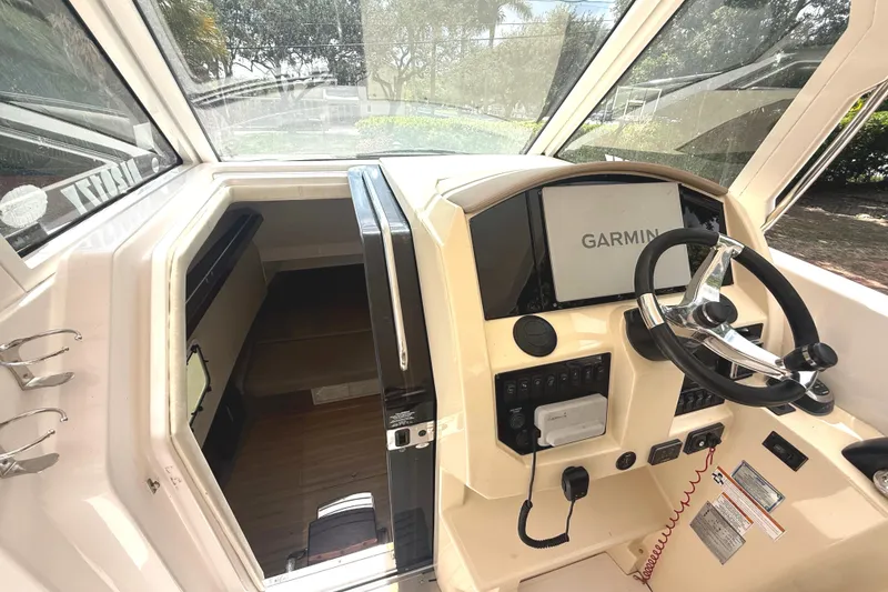 Slide: The Image of The image shows the cockpit of a 2019 Regal 33 SAV with a Garmin navigation system. - 16