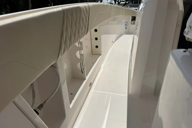 Slide: The Image of 2019 Regal 33 SAV boat interior with white seating and storage compartments. - 40