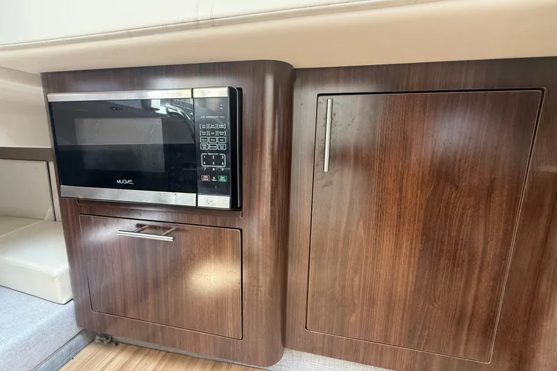 Slide: The Image of 2019 Regal 33 SAV interior with wood cabinetry and built-in microwave. - 19