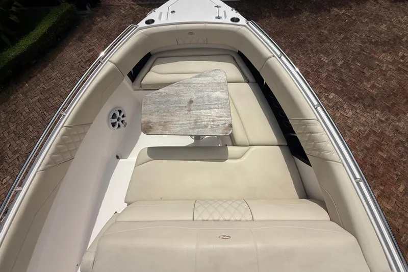 Slide: The Image of 2019 Regal 33 SAV boat interior with beige seating and wooden table. - 29