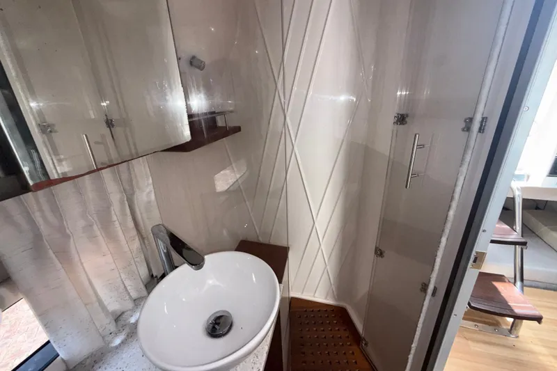 Slide: The Image of Luxurious bathroom interior of 2019 Regal 33 SAV boat with modern sink and shower. - 24