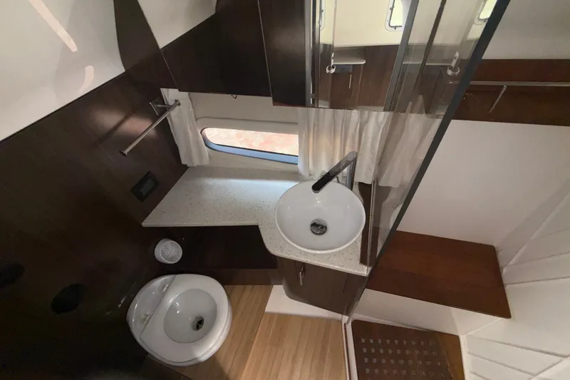 Slide: The Image of 2019 Regal 33 SAV bathroom interior with modern sink and wooden accents. - 25
