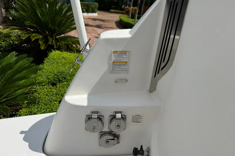 Slide: The Image of 2019 Regal 33 SAV boat detail with control panel and lush greenery background. - 42