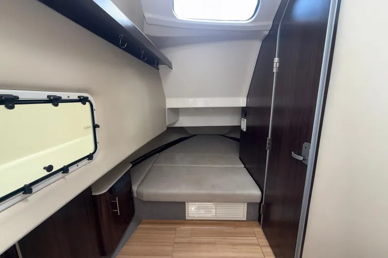Slide: The Image of 2019 Regal 33 SAV cabin interior with bed, window, and wooden flooring. - 26