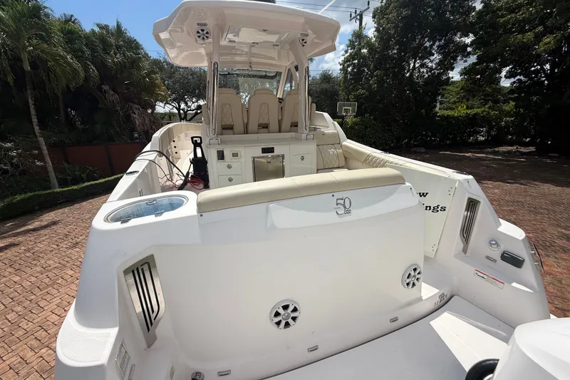 Slide: The Image of 2019 Regal 33 SAV boat with spacious seating and modern amenities, docked outdoors. - 43