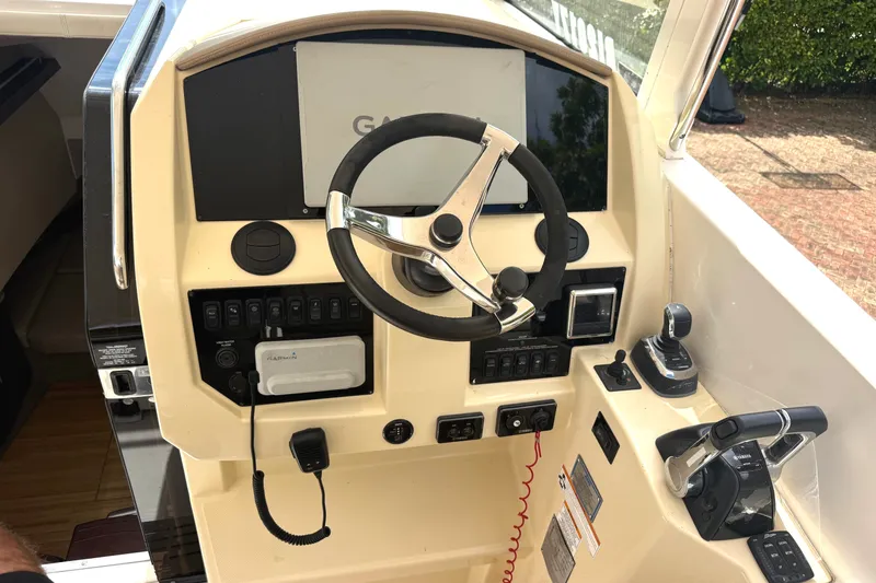 Slide: The Image of The image shows the helm of a 2019 Regal 33 SAV boat with modern controls. - 15