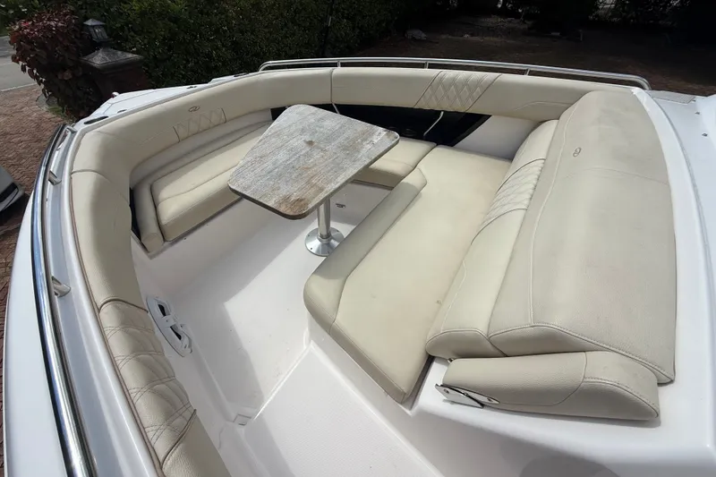 Slide: The Image of 2019 Regal 33 SAV boat interior with beige seating and a wooden table. - 30