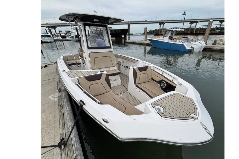 Slide: The Image of 2022 Yamaha Boats 255 FSH Sport E docked, showcasing sleek design and spacious seating. - 7