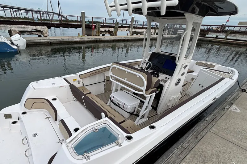 Slide: The Image of 2022 Yamaha Boats 255 FSH Sport E docked, showcasing sleek design and spacious interior. - 9
