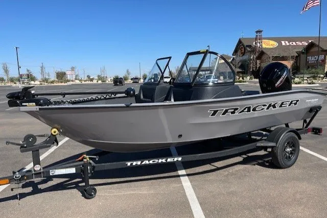 The Image of 2027 Tracker Pro Guide V-16 WT boat on trailer in parking lot. - 0
